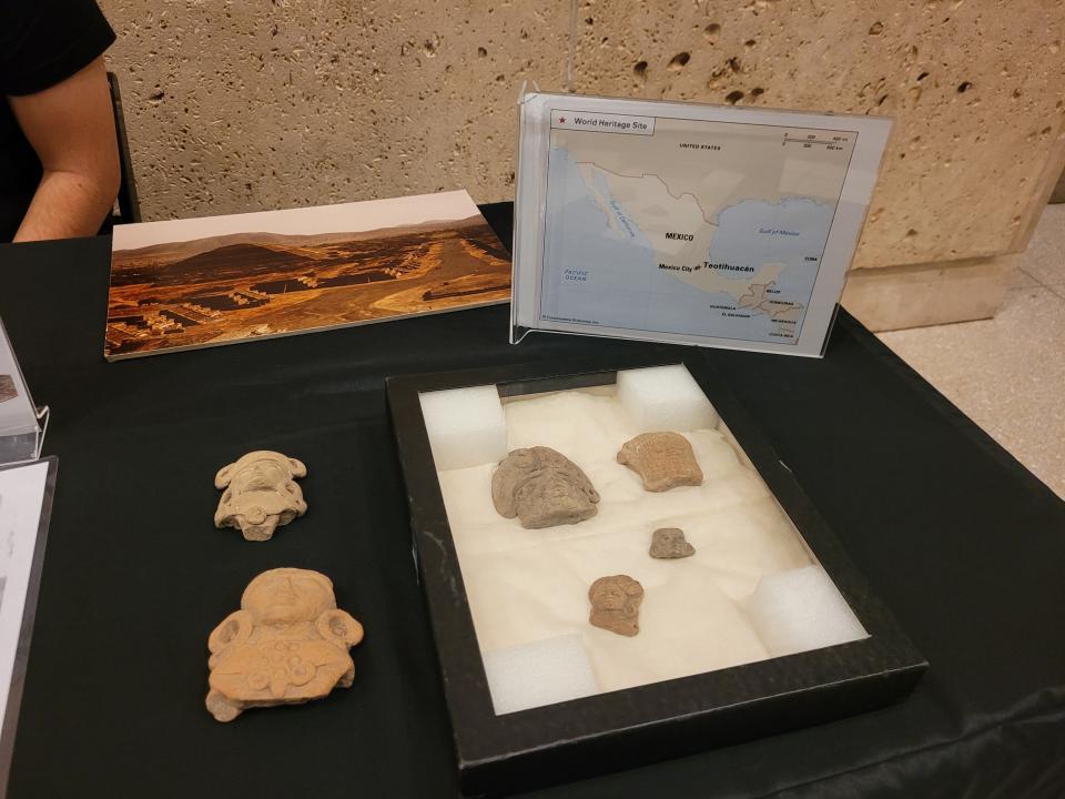 Emiliano Rodriguez, an educator at the Milwaukee Public Museum, displays re-creations of artifacts discovered in Mexico.