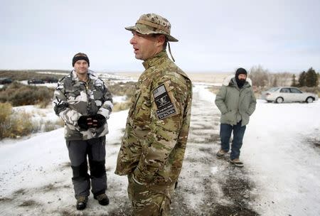 Militiamen stand on a road at the Malheur National Wildlife Refuge near Burns, Oregon, January 4, 2016. REUTERS/Jim Urquhart/File Photo