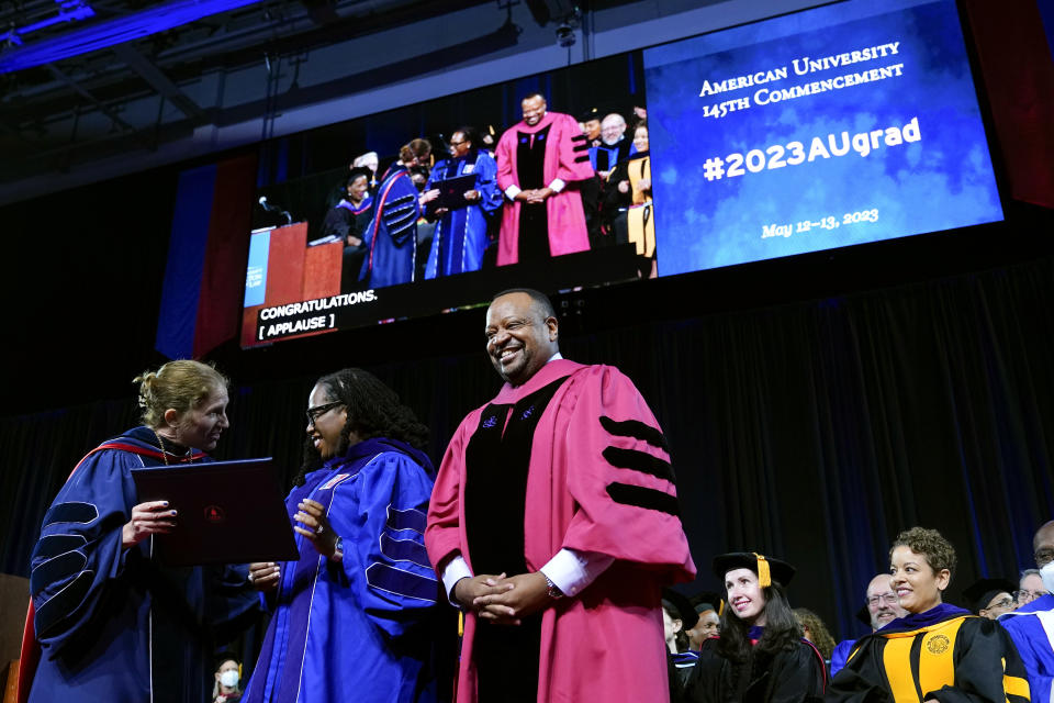 Supreme Court Associate Justice Ketanji Brown Jackson receives an honorary degree from American University President Sylvia Burwell, left, and American University Washington College of Law Dean Roger Fairfax at the commencement ceremony for American's Washington College of Law, Saturday, May 20, 2023, in Washington. (AP Photo/Patrick Semansky)