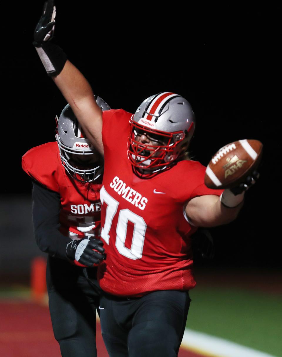 Somers' Jake Polito (70) celebrates after catching a deflected pass in the end zone on a 2-point conversion against Spring Valley during football action at Somers High School April 16, 2021. Somers won the game 32-8.