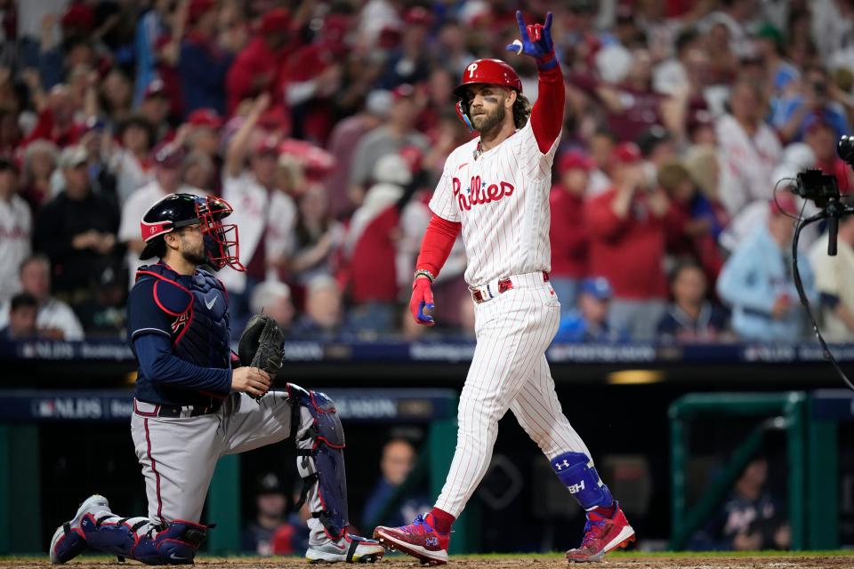 Philadelphia Phillies' Bryce Harper reacts after hitting a home run during the fifth inning of Game 3 of a baseball NL Division Series against the Atlanta Braves Wednesday, Oct. 11, 2023, in Philadelphia.