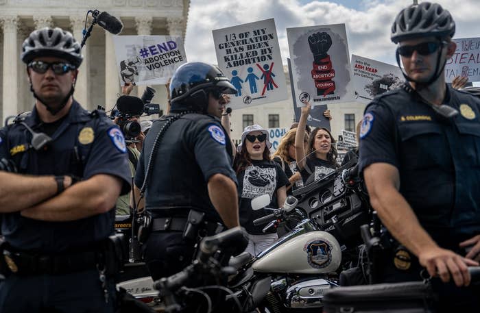 police standing in front of peaceful protesters