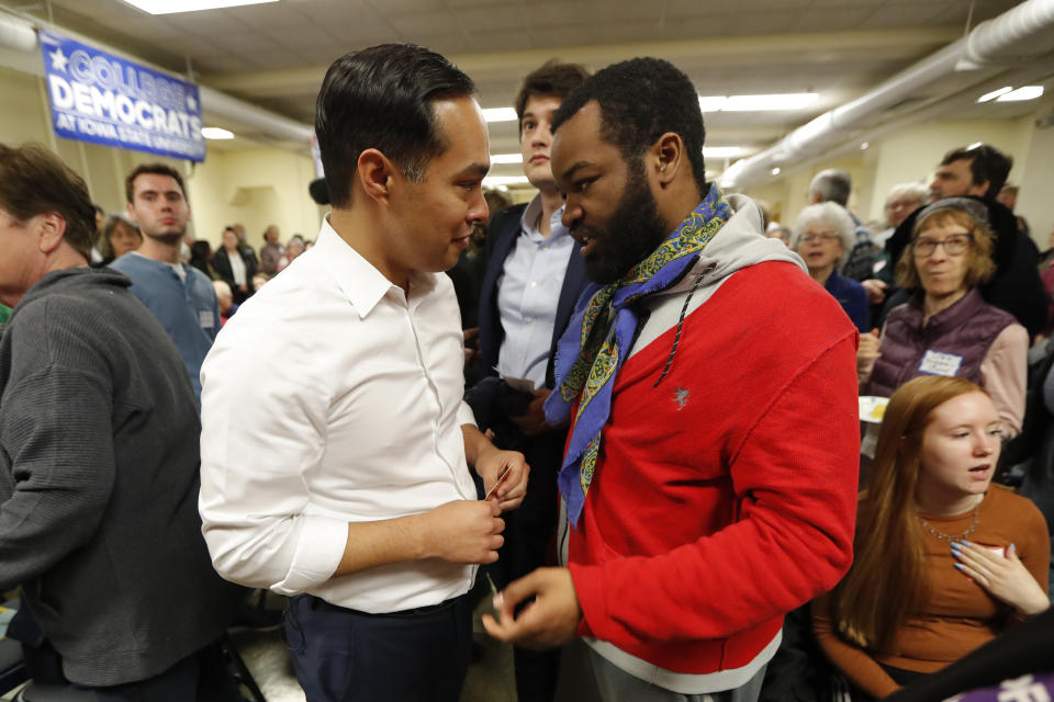 Former Housing and Urban Development Secretary and 2020 Democratic presidential hopeful Julian Castro talks with Lemuel Anderson, of Des Moines, Iowa, right, at the Story County Democrats' annual soup supper fundraiser, Saturday, Feb. 23, 2019, in Ames, Iowa. (AP Photo/Charlie Neibergall)