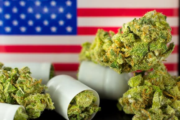 Marijuana buds in front of a U.S. flag.