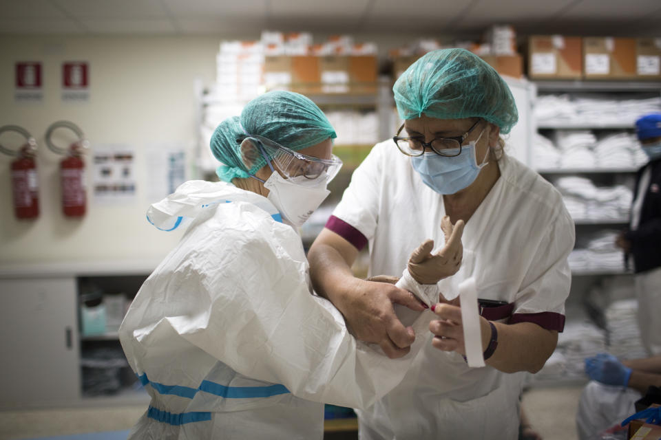 An health worker dresses in a protective suit at the intensive care unit of San Filippo Neri Hospital in Rome on April 8, 2020,  during the Coronavirus emergency. Italy is continuing to take measures to contain the widespread of the SARS-CoV-2 coronavirus which causes the Covid-19 disease. (Photo by Christian Minelli/NurPhoto via Getty Images)