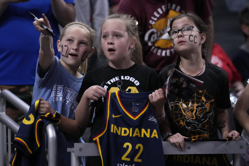 Fans watch Indiana Fever guard Caitlin Clark warm up for the team's WNBA basketball game against the New York Liberty, Thursday, May 16, 2024, in Indianapolis. (AP Photo/Michael Conroy)