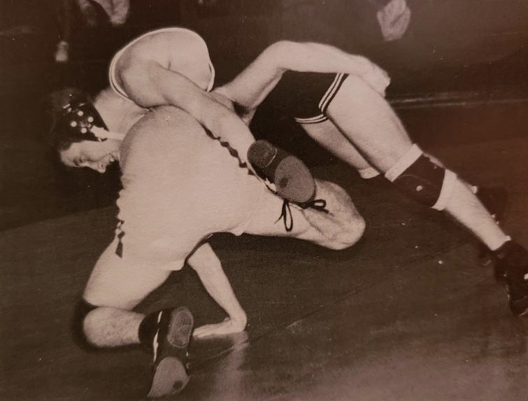 A Shippensburg High School yearbook photo captures Bill Wolfe Jr. attempting to pin an opposing wrestler. (photo via Frankie O’Brien)