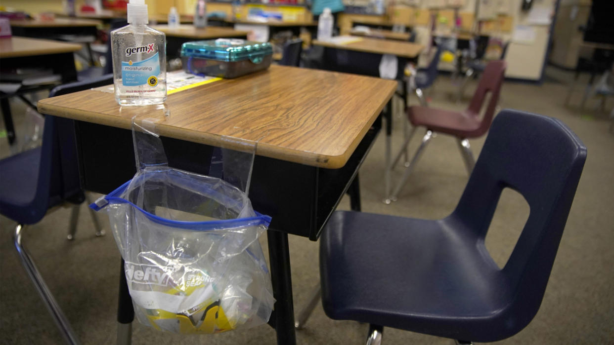 A teacher prepares her classroom before students arrive for school at Freedom Preparatory Academy on February 10, 2021 in Provo, Utah. (George Frey/Getty Images)