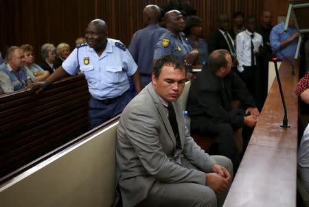 Farmer Willem Oosthuizen sits in the dock before facing sentencing for kidnap, assault and attempted murder, in connection with forcing a man into a coffin, in Middelburg, South Africa, October 27, 2017. REUTERS/Siphiwe Sibeko