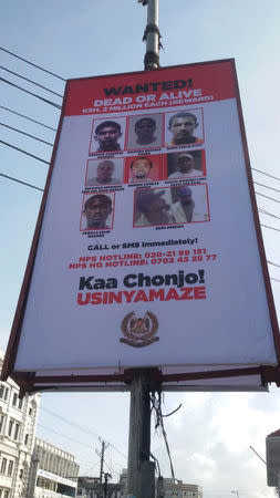 Kenyan police billboard with the headline "wanted dead or alive" displays the photo of Mahir Khalid Riziki (top right) who is suspected of being the suicide bomber who blew himself up in the January 15, 2019 attack on an upscale Nairobi hotel, in Mombasa, Kenya April 16, 2015. REUTERS/Joseph Akwiri