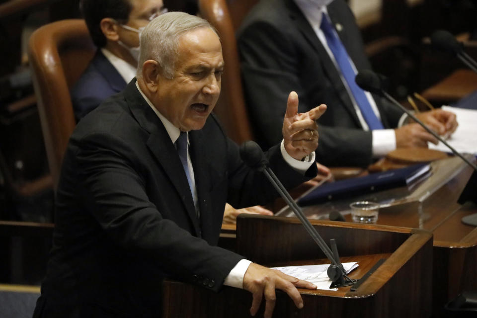 FILE - Former Israeli Prime Minister Benjamin Netanyahu speaks during a session of the Knesset, Israel's parliament, in Jerusalem, Monday, Oct. 4, 2021. Netanyahu watched from the sidelines Thursday as the government that toppled him after 12 years in power passed a national budget, dealing a major blow to his hopes of a swift return to the country's top office. (AP Photo/Ariel Schalit, File)