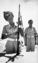 FILE - In this Feb. 25, 1978 file photo, a Somali Army female recruit checks her automatic weapon at a military training camp in Halane, Mogadishu. At right is her instructor. On Friday, Aug. 23, 2019, The Associated Press reported on this photo circulating online, incorrectly identified as showing U.S. Rep. Ilhan Omar, D-Minn., undergoing military training. This black-and-white film image was made before Omar was born. (AP Photo)