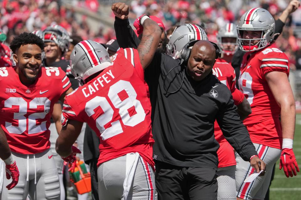 Apr 13, 2024; Columbus, OH, USA; Ohio State Buckeyes running backs coach Carlos Locklyn celebrates a touchdown with Ohio State Buckeyes running back TC Coffey (28) during the Ohio State football spring game at Ohio Stadium.