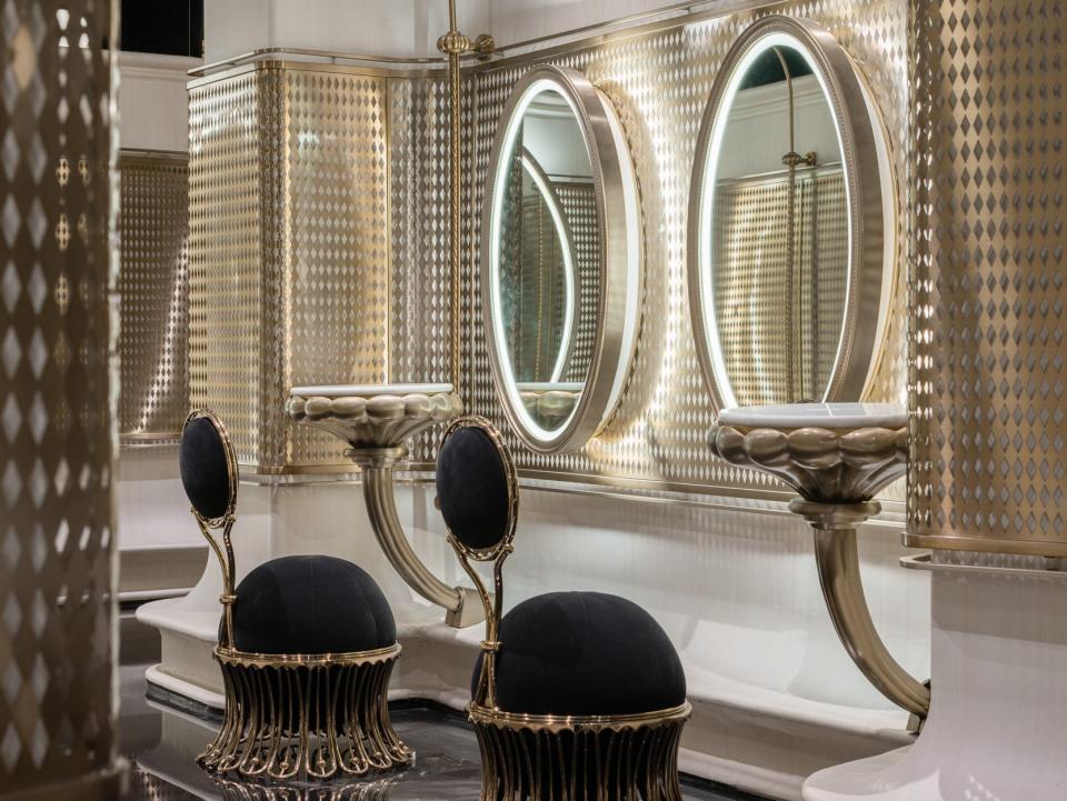 The vanity corner comes with backlit mirrors and chairs.