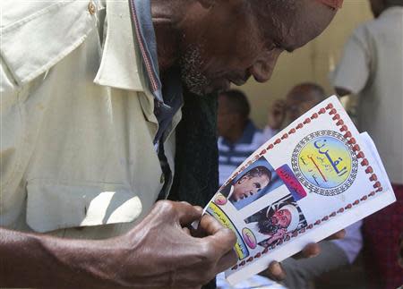 A man reads a book at a bookstall in southern Mogadishu October 10, 2013. REUTERS/Feisal Omar