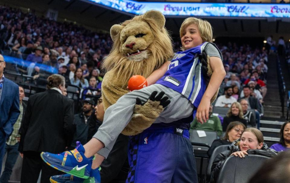 Seven-year-old Dutch Newsom, Gov. Gavin Newsom’s son, is picked up by Slamson at a Sacramento Kings at Golden 1 Center in March.