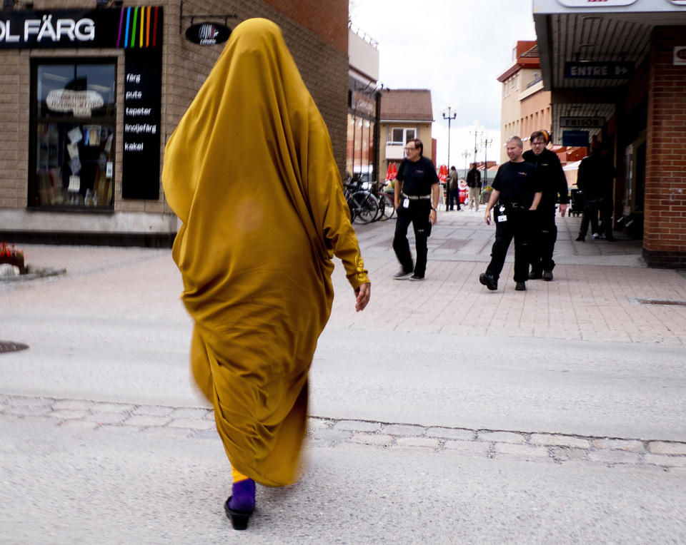 In this Aug. 30, 2018 photo a migrant from Somalia walks through downtown Flen, some 100 km west of Stockholm, Sweden. The town has welcomed so many asylum seekers in recent years that they now make up about a fourth of the population. (AP Photo/Michael Probst)