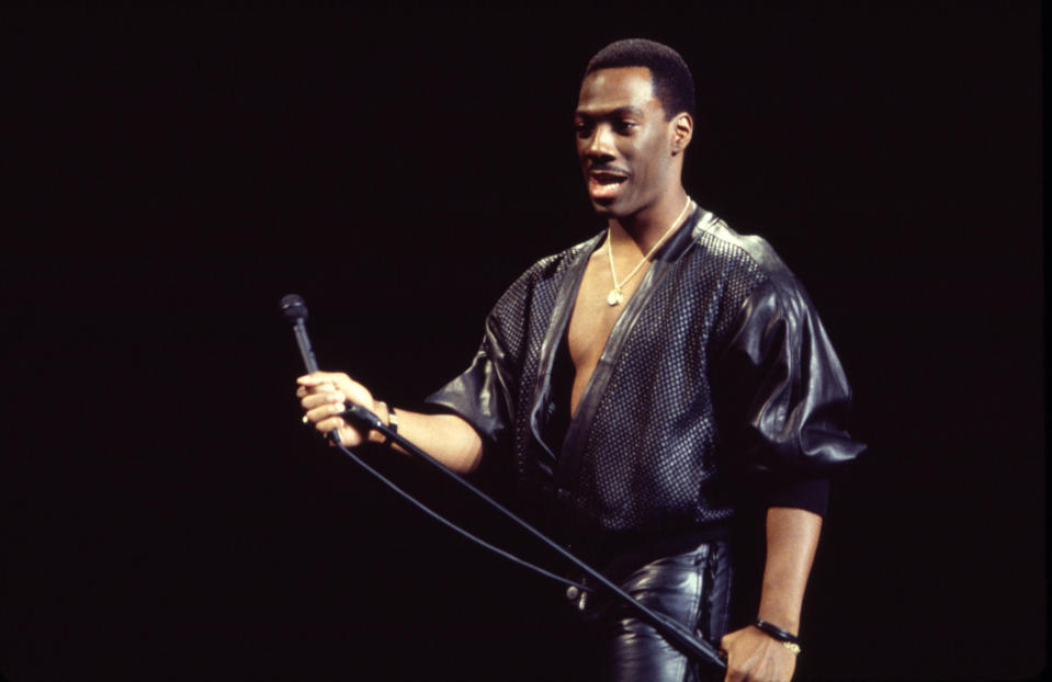 Eddie Murphy performs at Madison Square Garden during his 'Raw Tour' on October 13, 1987. (Photo by Gary Gershoff/Getty Images)