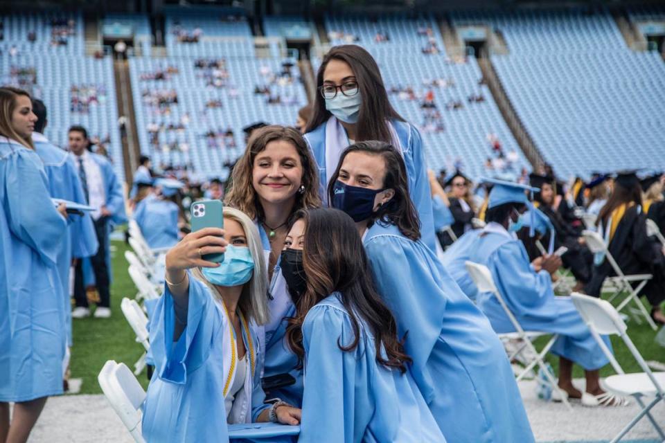 Students gather for a “selfie” prior to a commencement ceremony at UNC-Chapel Hill Friday, May 14, 2021.