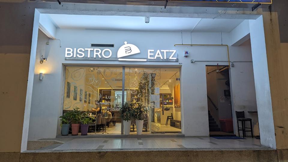 Look for the white sign on the inside for Bistro Eatz.