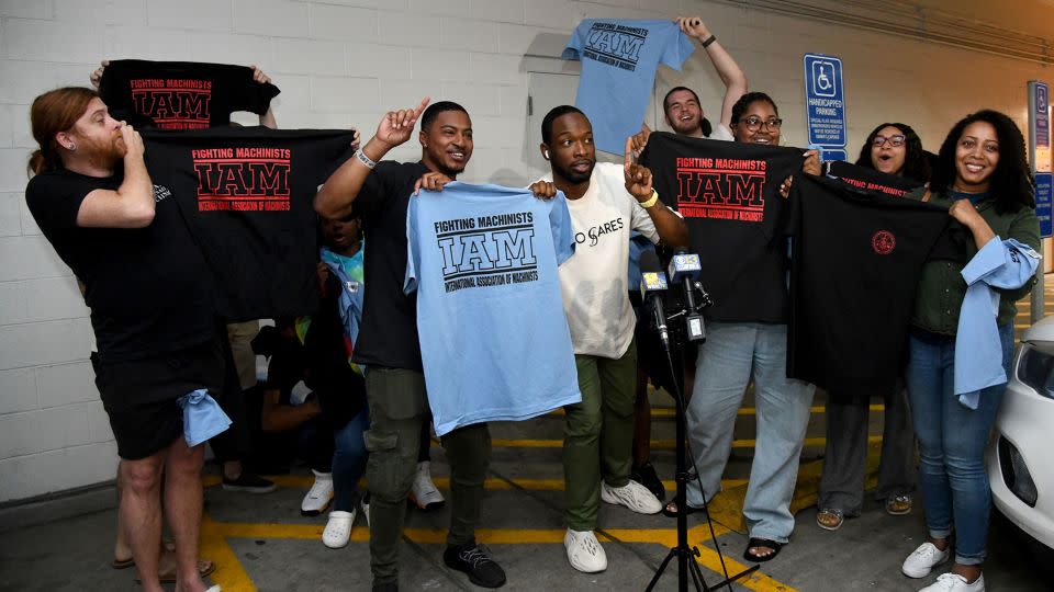 Workers at the Towson Town Center Apple hold their new union T-shirts after their store employees decided to join the International Association of Machinists Union. Theirs is the first Apple store in the US to vote for union representation. (Barbara Haddock Taylor/The Baltimore Sun/Tribune News Service via Getty Images) - Barbara Haddock Taylor/The Baltimore Sun/Tribune News Service/Getty Images