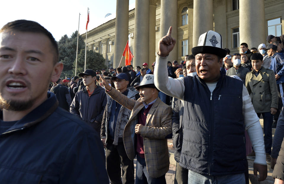 People protest during a rally on the central square in Bishkek, Kyrgyzstan, Wednesday, Oct. 7, 2020. Officials in Kyrgyzstan have nullified the results of a weekend parliamentary election after mass protests erupted in the capital of Bishkek and other cities, with opposition supporters seizing government buildings and demanding a new vote. (AP Photo/Vladimir Voronin)