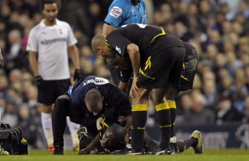 Fabrice Muamba receives treatment after collapsing during the FA Cup quarter-final between Tottenham Hotspur and Bolton Wanderers at White Hart Lane on March 17. Muamba has retired from playing professional football on health grounds, the English second-tier club said on their website Thursday