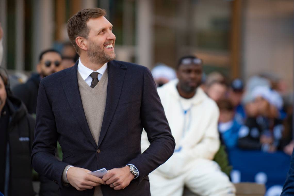 Dirk Nowitzki smiles as he peers at his statue during the “All Four One” statue ceremony in front of the American Airlines Center in Dallas, Sunday, Dec. 25, 2022. (AP Photo/Emil T. Lippe)