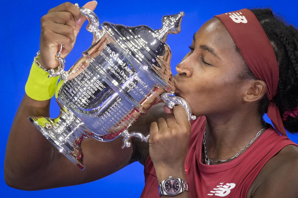 Coco Gauff, of the United States, poses for photographs after defeating Aryna Sabalenka, of Belarus, at the women's singles final of the U.S. Open tennis championships, Saturday, Sept. 9, 2023, in New York. (AP Photo/John Minchillo)