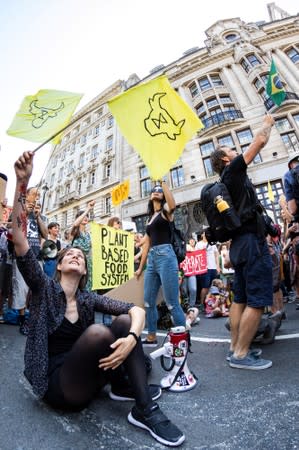 People demonstrate during an Extinction Rebellion protest outside the Brazilian embassy in London