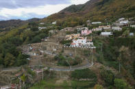 An aerial view of damaged houses after heavy rainfall triggered landslides that collapsed buildings and left as many as 12 people missing, in Casamicciola, on the southern Italian island of Ischia, Sunday, Nov. 27, 2022. Authorities said that the landslide that early Saturday destroyed buildings and swept parked cars into the sea left one person dead and 12 missing. (AP Photo/Salvatore Laporta)