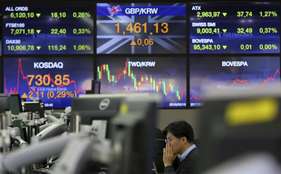 A currency trader watches monitors at the foreign exchange dealing room of the KEB Hana Bank headquarters in Seoul, South Korea, Monday, Feb. 11, 2019. Asian stocks were mixed on Monday as traders watched for developments on a fresh round of trade talks in Beijing this week. (AP Photo/Ahn Young-joon)