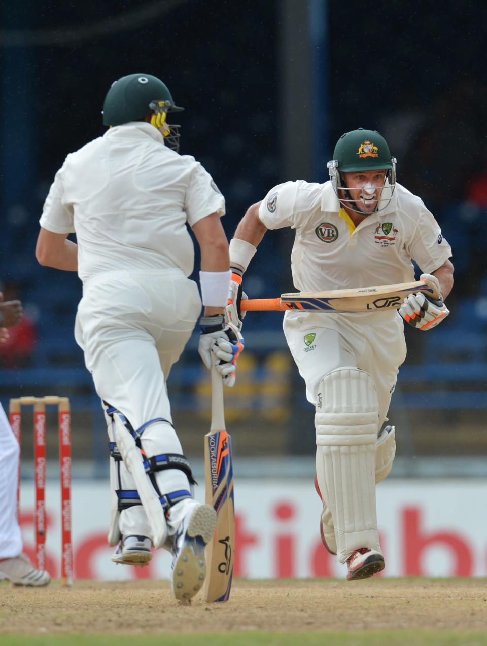 Australian batsmen Michael Hussey (R) and James Pattinson (L) run during the second day of the second-of-three Test matches between Australia and West Indies April 16, 2012 at Queen's Park Oval in Port of Spain. AFP PHOTO/Stan HONDA (Photo credit should read STAN HONDA/AFP/Getty Images)