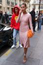 <p>The supermodel paired a vibrant orange Bottega Veneta pouch bag with pink sequin dress for another restaurant visit. </p>