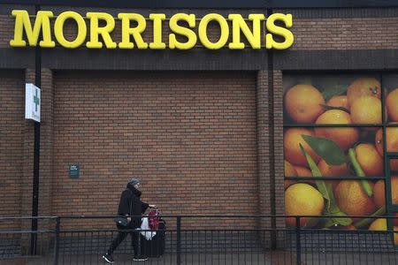 A shopper walks past a branch of the food retailer Morrisons in west London, Britain, January 7, 2017. REUTERS/Toby Melville