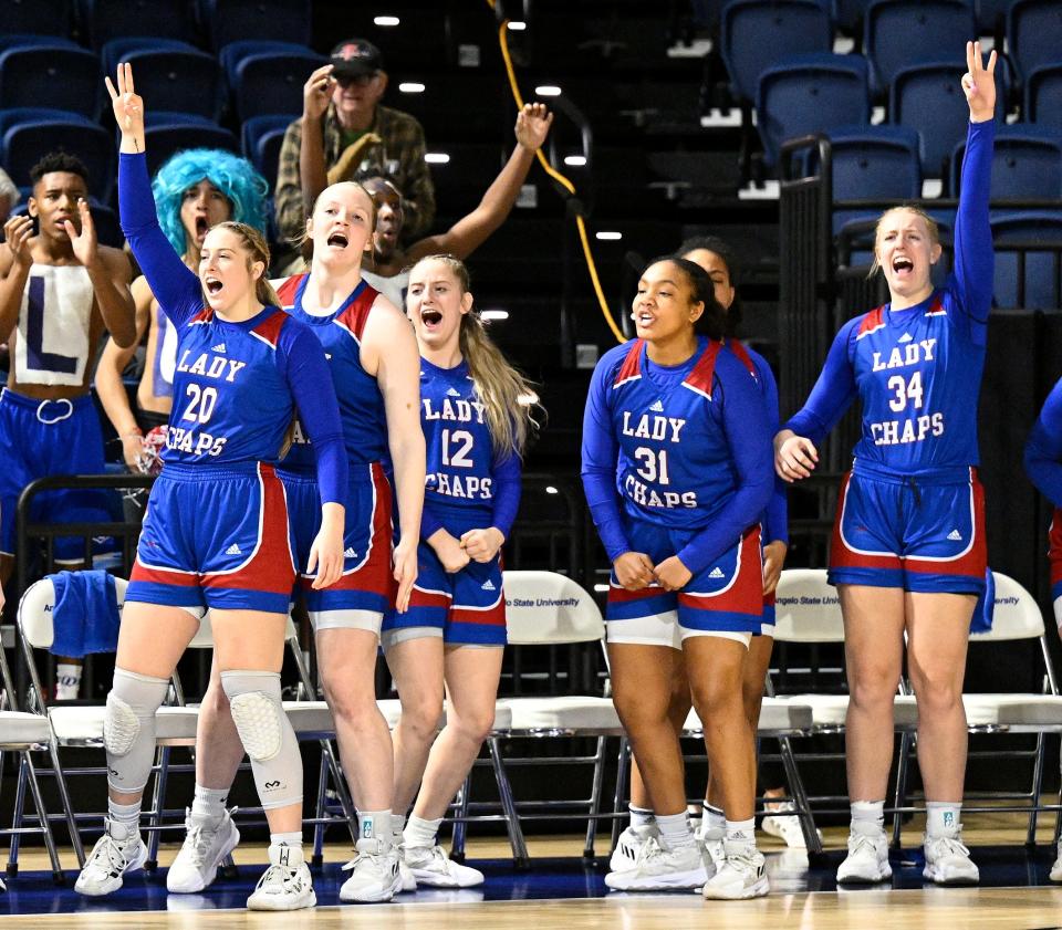 Lubbock Christian University players celebrate a 3-point goal during the Lady Chaps' 62-55 victory over Texas Woman's in Friday's first round of the Division II NCAA Tournament in San Angelo.