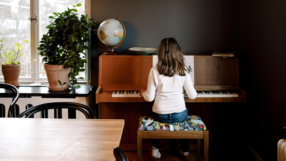 Girl playing piano at home