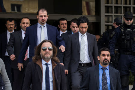 The eight Turkish soldiers, who fled to Greece in a helicopter and requested political asylum after a failed military coup against the government, are escorted by police officers as they leave the Supreme Court in Athens, Greece, January 23, 2017. REUTERS/Alkis Konstantinidis