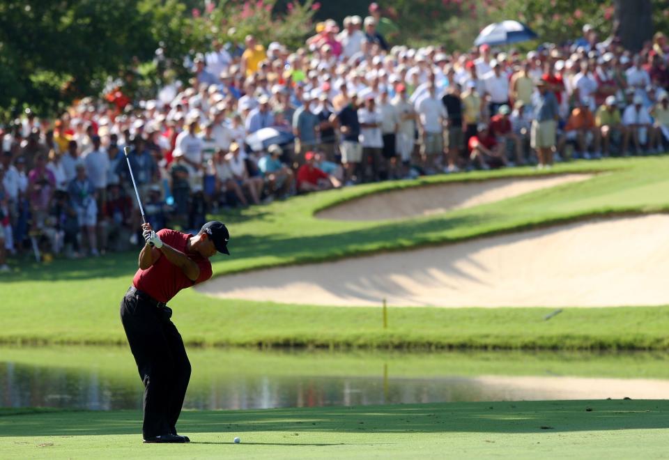 Tiger Woods hits his approach shot on the 13th hole during the final round of the 89th PGA Championship at the Southern Hills in Tulsa on Aug. 12, 2007.