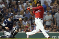 Boston Red Sox's Rafael Devers strikes out swinging next to New York Yankees catcher Gary Sanchez to end the third inning of a baseball game at Fenway Park, Friday, July 23, 2021, in Boston. (AP Photo/Elise Amendola)