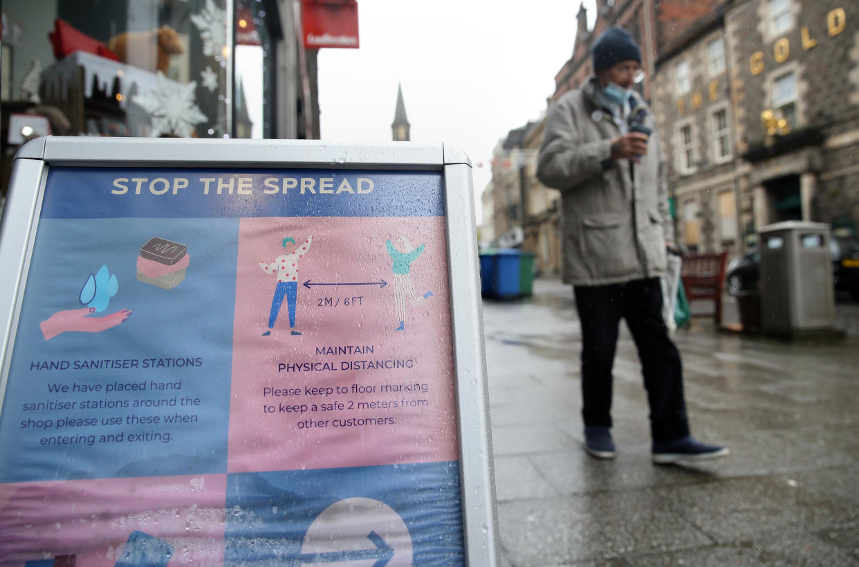 A sign advising customers about the spread of coronavirus outside a shop in Stirling. Scotland is currently using a tier system to try and drive down coronavirus cases.