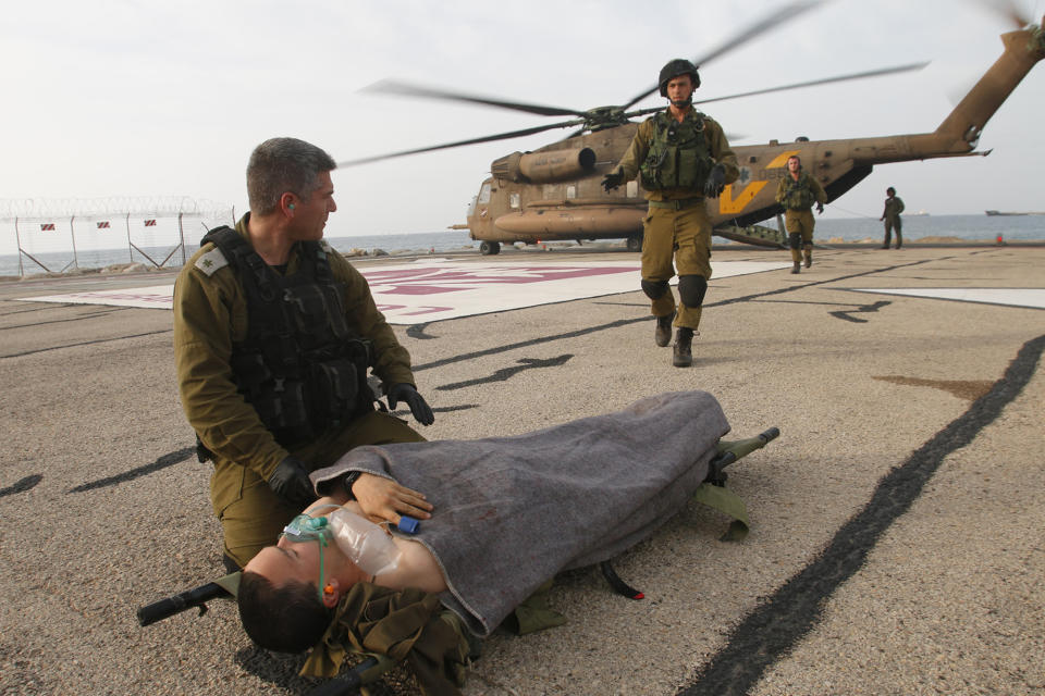 A wounded Israeli soldier is brought to a hospital in Haifa, Israel, Tuesday, March 18, 2014. A roadside bomb hit an Israeli patrol near the frontier with the Golan Heights on Tuesday, the army said, wounding four soldiers in the most serious violence to strike the area since the Syrian conflict began three years ago. Israel said it responded with artillery strikes on Syrian army targets. Israel captured the Golan Heights from Syria in the 1967 Middle East war and later annexed the strategic area in a move that was not internationally recognized. (AP Photo/Hertzel Shapira) ****ISRAEL OUT***