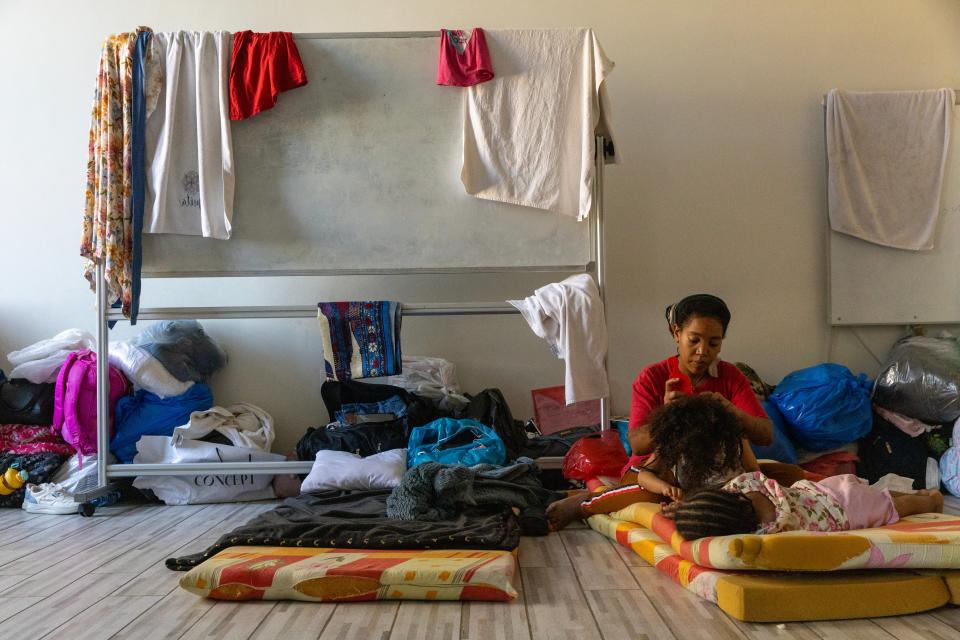 Internally displaced mother braids one daughter’s hair inside while the other naps at Saint Joseph Church, which is being used as IDP shelter in Beirut, Lebanon (Getty Images)