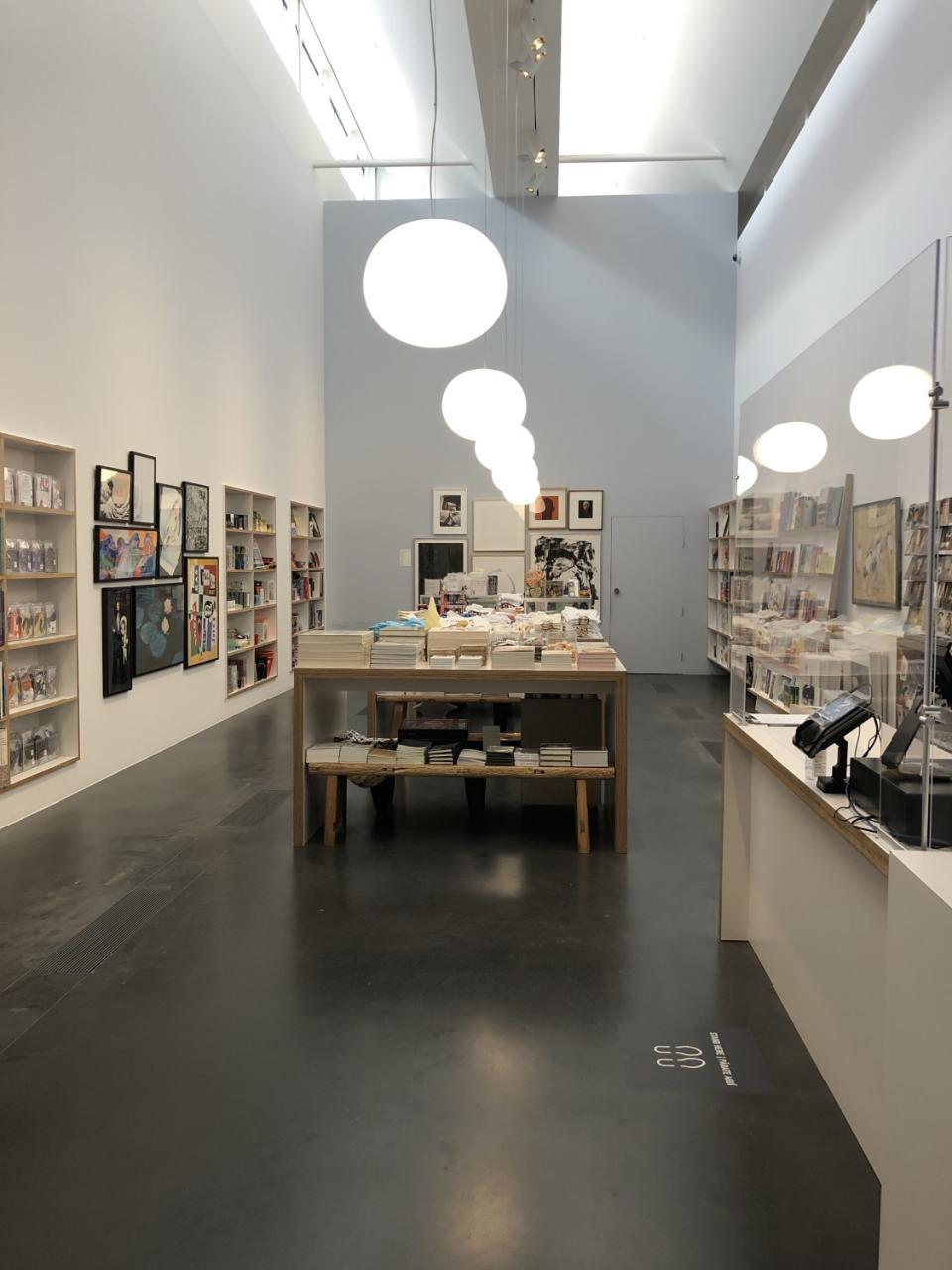 A museum gift shop lined with books and other goods.