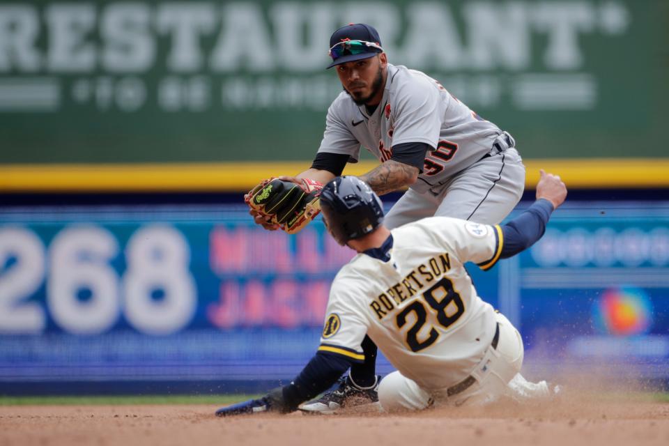 Detroit Tigers' Harold Castro forces out Milwaukee Brewers' Daniel Robertson (28) at second base during the sixth inning of a baseball game Monday, May 31, 2021, in Milwaukee.