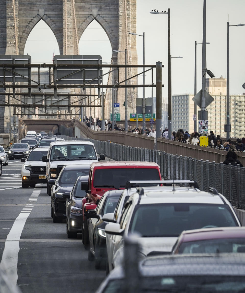 Traffic enters lower Manhattan after crossing the Brooklyn Bridge, Thursday, Feb. 8, 2024, in New York. The Big Apple is close to implementing a plan that would use license-plate readers to turn all of Manhattan south of Central Park into one giant toll zone. (AP Photo/Bebeto Matthews)