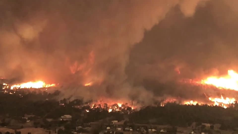 A fire tornado turns on July 26, 2018, over Lake Keswick Estates near Redding, California, during the Carr Fire, this image from Cal Fire video shows.  - Cal Fire/AP