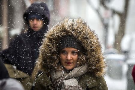 A pedestrian walks through a snow storm in New York March 5, 2015. REUTERS/Lucas Jackson