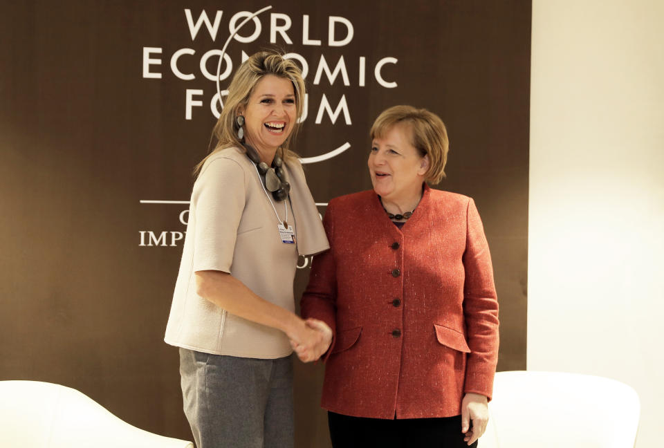 German Chancellor Angela Merkel meets with Queen Maxima of the Netherlands, left, at the annual meeting of the World Economic Forum in Davos, Switzerland, Wednesday, Jan. 23, 2019. (AP Photo/Markus Schreiber)