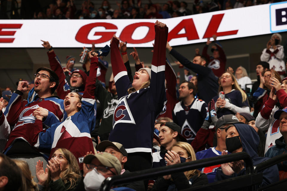 Fans of the Colorado Avalanche cheer.